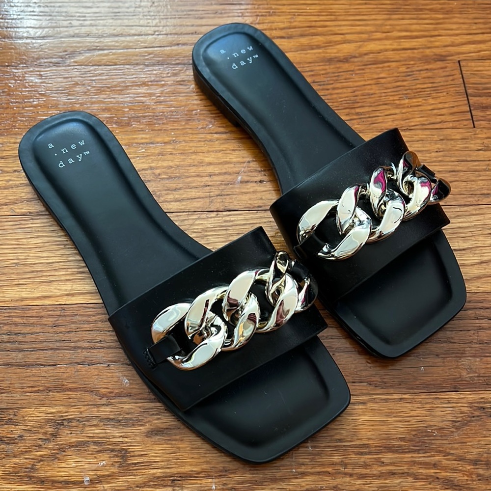 Size 7 black sandals with gold chain.